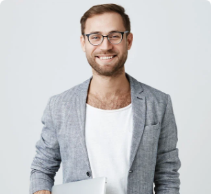 a man wearing glasses and a grey jacket